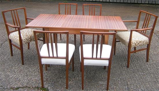 A Gordon Russell teak extending dining table and six chairs (4+2 carvers)